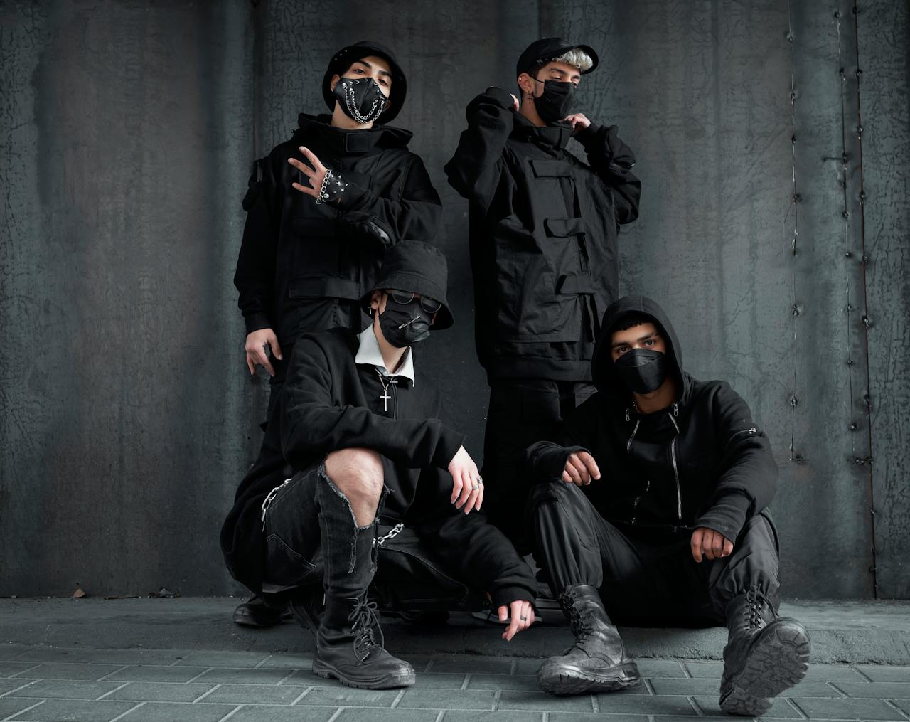 A group of fashionable men in black, posing with style in Tehran, showcasing urban street fashion.
